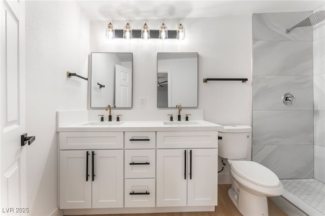 915 Melrose Dr, Las Vegas, NV 89101 - bathroom featuring tiled shower, double vanity, and wood finished floors