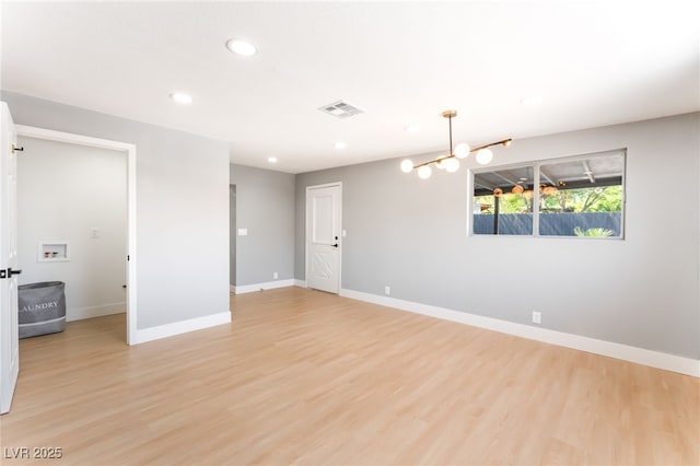 915 Melrose Dr, Las Vegas, NV 89101 - empty room with recessed lighting, light wood-style floors, and a chandelier