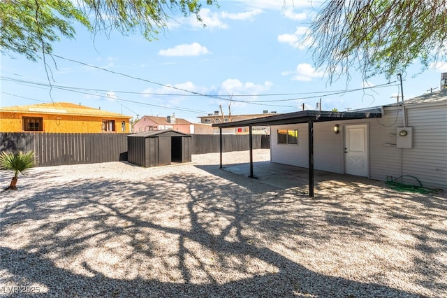 915 Melrose Dr, Las Vegas, NV 89101 - fenced backyard featuring a storage shed, a patio area, and a carport