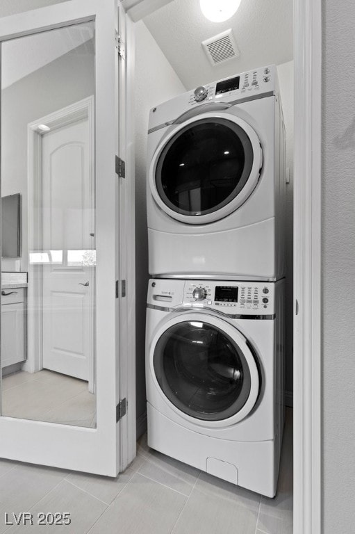 6338 Skystone St, Las Vegas, NV 89135 - laundry room featuring stacked washer / dryer and light tile patterned floors