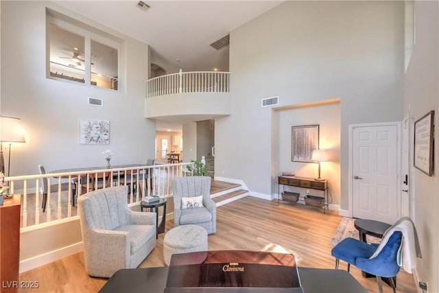 8221 Ebony Peak St, Las Vegas, NV 89143 - living area featuring a high ceiling, wood finished floors, and a ceiling fan