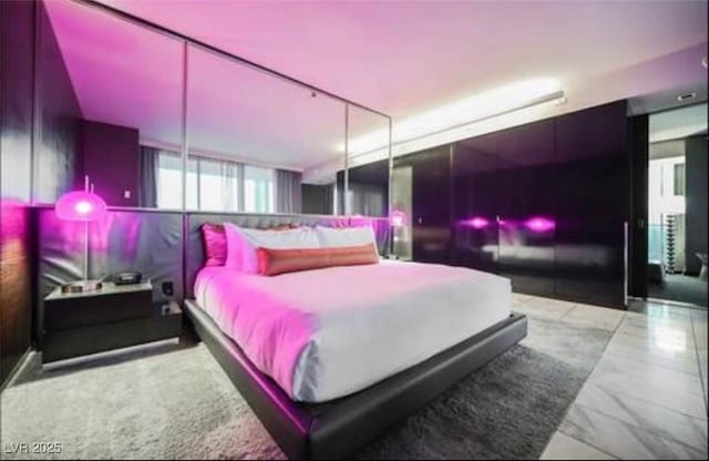 4381 W Flamingo Rd Unit 2902, Las Vegas, NV 89103 - bedroom featuring marble finish flooring and multiple windows