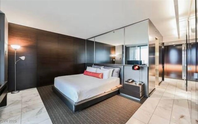 4381 W Flamingo Rd Unit 2902, Las Vegas, NV 89103 - bedroom with marble finish flooring and an accent wall