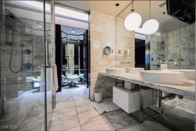 4381 W Flamingo Rd Unit 2902, Las Vegas, NV 89103 - full bath featuring marble finish flooring, a shower stall, tile walls, and vanity