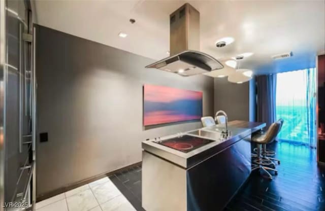 4381 W Flamingo Rd Unit 2902, Las Vegas, NV 89103 - kitchen with island range hood and baseboards