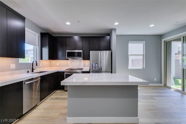 649 Tranquil Jade St, Las Vegas, NV 89138 - kitchen with stainless steel appliances, light wood-style floors, dark cabinets, and recessed lighting