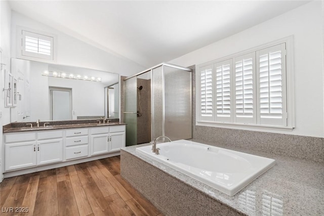 8113 Blue Cascade Ave, Las Vegas, NV 89128 - full bath featuring double vanity, a shower stall, a bath, lofted ceiling, and wood finished floors