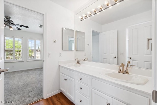 8113 Blue Cascade Ave, Las Vegas, NV 89128 - bathroom with double vanity, ceiling fan, and wood finished floors