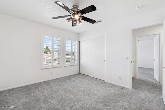 8113 Blue Cascade Ave, Las Vegas, NV 89128 - unfurnished bedroom with carpet flooring, a closet, and a ceiling fan