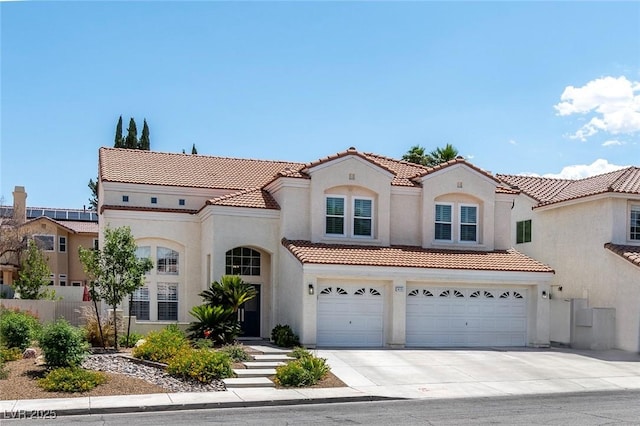 8113 Blue Cascade Ave, Las Vegas, NV 89128 - mediterranean / spanish-style house with stucco siding, a tile roof, concrete driveway, and a garage