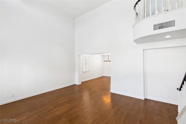 8113 Blue Cascade Ave, Las Vegas, NV 89128 - unfurnished room with wood finished floors and a towering ceiling