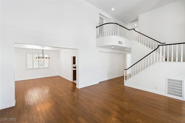 8113 Blue Cascade Ave, Las Vegas, NV 89128 - unfurnished living room with a chandelier, hardwood / wood-style floors, stairs, and a high ceiling