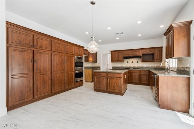 8113 Blue Cascade Ave, Las Vegas, NV 89128 - kitchen with double oven, a kitchen island with sink, backsplash, recessed lighting, and stone counters