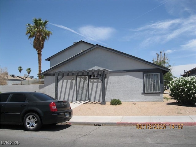 4015 Edgeford Pl, Las Vegas, NV 89102 - view of front facade featuring stucco siding, a garage, and a pergola