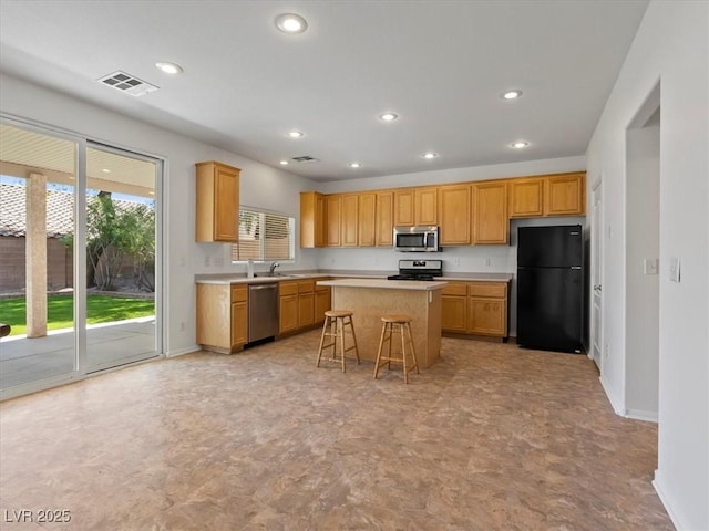 4905 Apache Valley Ave, Las Vegas, NV 89131 - kitchen featuring stainless steel appliances, light countertops, recessed lighting, a kitchen island, and a breakfast bar