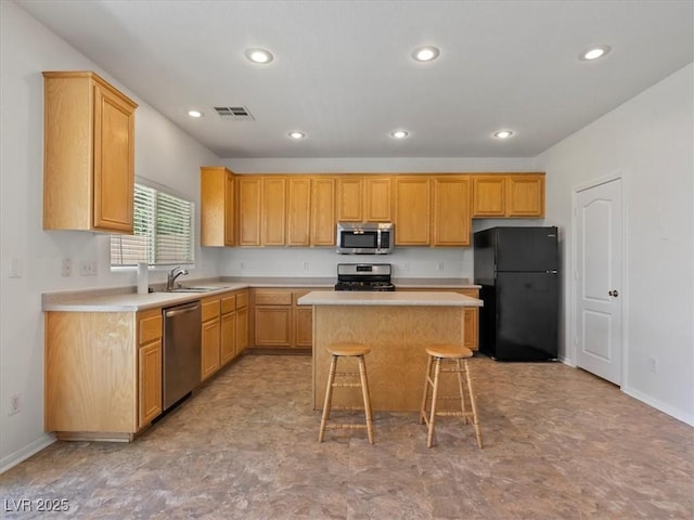 4905 Apache Valley Ave, Las Vegas, NV 89131 - kitchen featuring appliances with stainless steel finishes, a kitchen island, light countertops, light floors, and recessed lighting