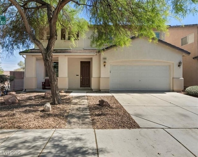 4905 Apache Valley Ave, Las Vegas, NV 89131 - view of front of home featuring stucco siding, a garage, and driveway
