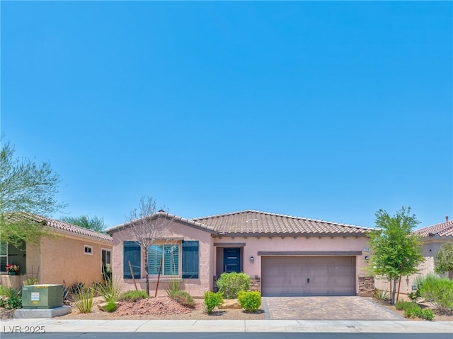 280 Via Del Duomo, Henderson, NV 89011 - mediterranean / spanish home with a tile roof, stucco siding, an attached garage, driveway, and stone siding