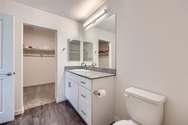 12282 Azure Gate Rd Unit 4, Las Vegas, NV 89183 - bathroom with vanity, wood finished floors, and a walk in closet