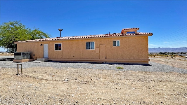 2530 Commercial Dr, Pahrump, NV 89048 - rear view of house featuring a tiled roof and a mountain view