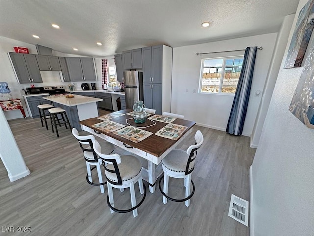 2530 Commercial Dr, Pahrump, NV 89048 - dining space with light wood finished floors, plenty of natural light, and recessed lighting