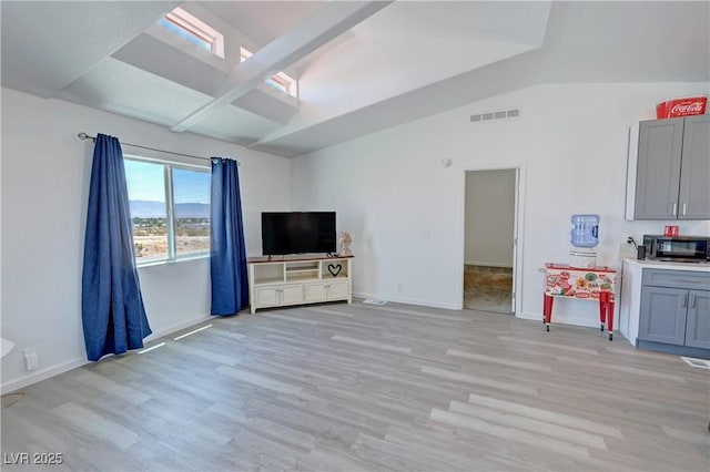 2530 Commercial Dr, Pahrump, NV 89048 - unfurnished living room featuring light wood-style floors and lofted ceiling