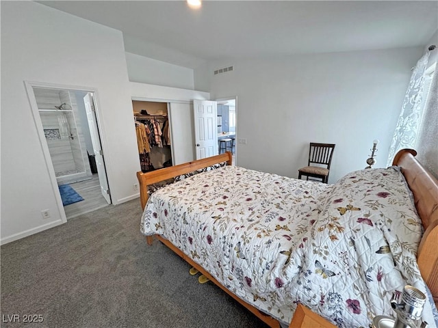 2530 Commercial Dr, Pahrump, NV 89048 - carpeted bedroom with lofted ceiling, a closet, ensuite bath, and a spacious closet