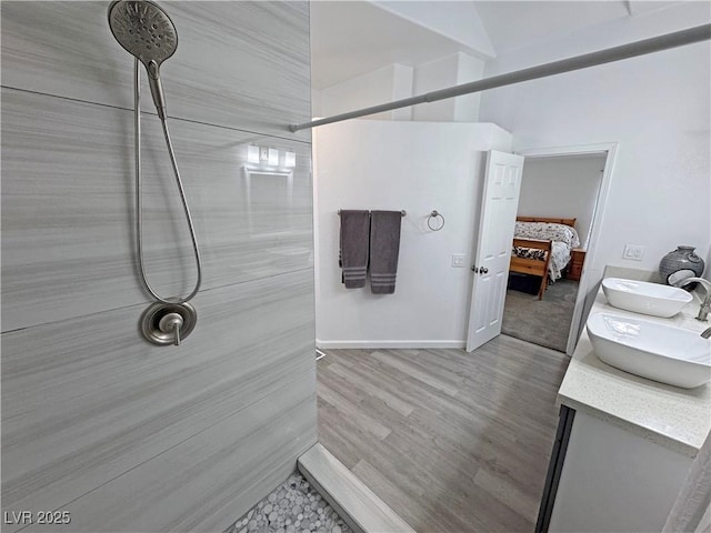 2530 Commercial Dr, Pahrump, NV 89048 - ensuite bathroom featuring double vanity, a tile shower, and wood finished floors