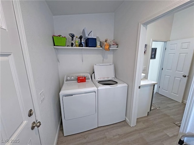 2530 Commercial Dr, Pahrump, NV 89048 - laundry room featuring independent washer and dryer and light wood-type flooring