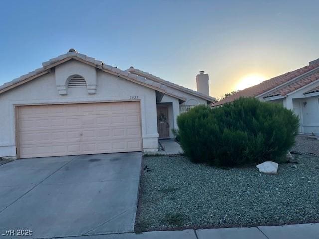 5429 Chela Dr, Las Vegas, NV 89120 - single story home with a chimney, concrete driveway, stucco siding, and an attached garage