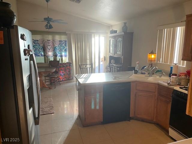 5429 Chela Dr, Las Vegas, NV 89120 - kitchen featuring stainless steel fridge with ice dispenser, dishwasher, gas stove, a peninsula, and vaulted ceiling