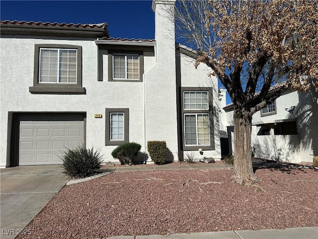 213 Luninborg St, Henderson, NV 89074 - view of front of home with stucco siding, a garage, a tiled roof, and a chimney