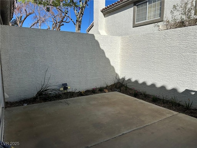 213 Luninborg St, Henderson, NV 89074 - view of side of home with stucco siding, a tile roof, and a patio