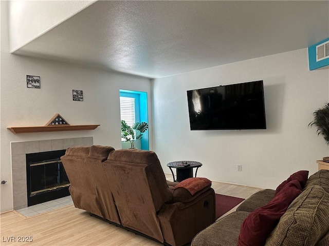 213 Luninborg St, Henderson, NV 89074 - living room featuring a fireplace and light wood-type flooring