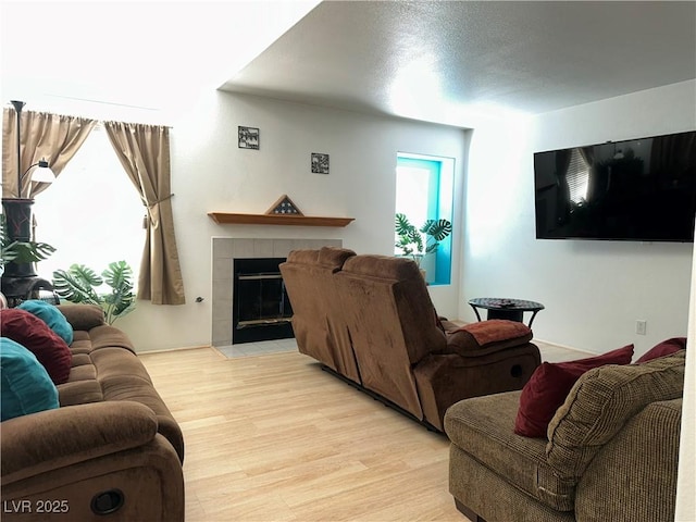 213 Luninborg St, Henderson, NV 89074 - living room with a tile fireplace and light wood finished floors