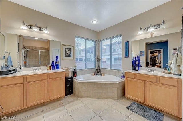9715 Aleutian St, Las Vegas, NV 89178 - full bathroom featuring a shower stall, tile patterned flooring, two vanities, and a garden tub