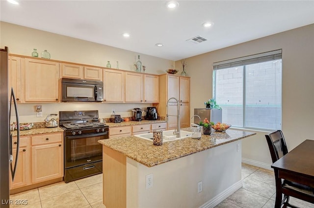 9715 Aleutian St, Las Vegas, NV 89178 - kitchen featuring black microwave, range with gas stovetop, light brown cabinetry, light tile patterned floors, and recessed lighting