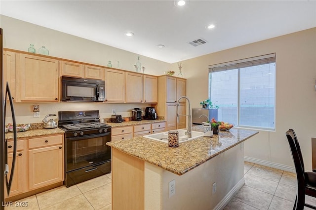 9715 Aleutian St, Las Vegas, NV 89178 - kitchen with black appliances, light brown cabinetry, light tile patterned floors, and recessed lighting