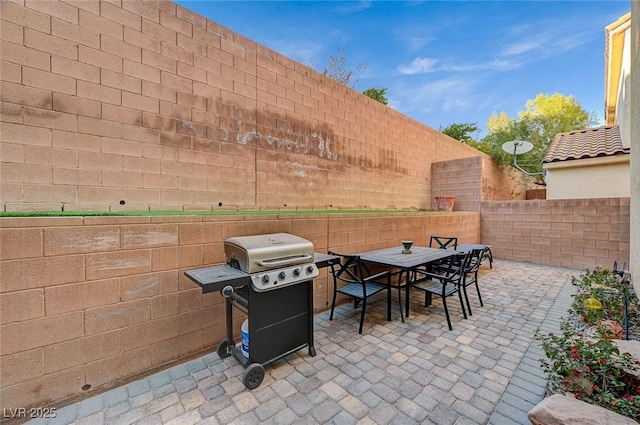 9715 Aleutian St, Las Vegas, NV 89178 - fenced backyard with area for grilling, outdoor dining area, and a patio area