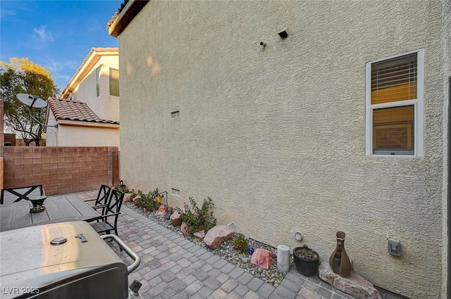 9715 Aleutian St, Las Vegas, NV 89178 - view of side of property featuring stucco siding and a patio area
