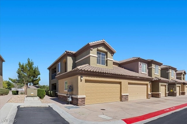 6868 Sky Pointe Dr Unit 2035, Las Vegas, NV 89131 - view of front of property with stone siding, stucco siding, a tile roof, and an attached garage