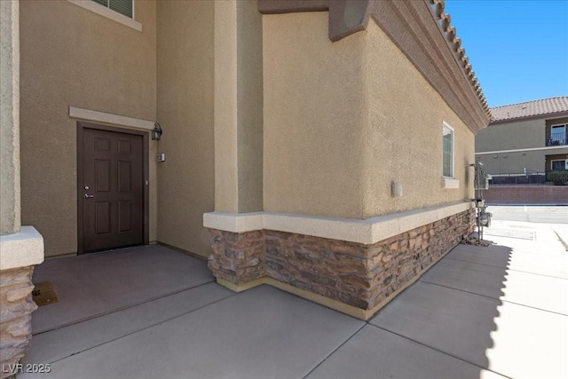 6868 Sky Pointe Dr Unit 2035, Las Vegas, NV 89131 - doorway to property featuring stucco siding and stone siding