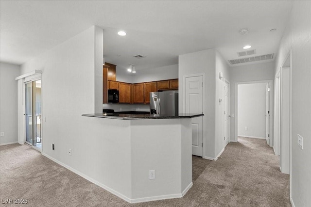 6868 Sky Pointe Dr Unit 2035, Las Vegas, NV 89131 - kitchen featuring stainless steel fridge with ice dispenser, black microwave, carpet, dark countertops, and brown cabinetry