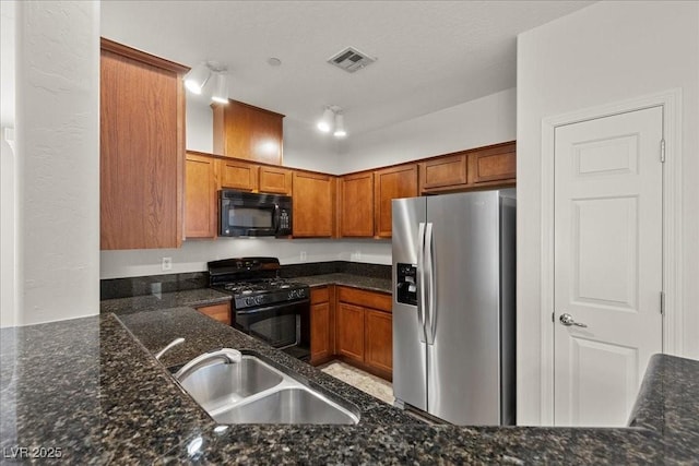 6868 Sky Pointe Dr Unit 2035, Las Vegas, NV 89131 - kitchen with black appliances, brown cabinetry, and dark stone countertops
