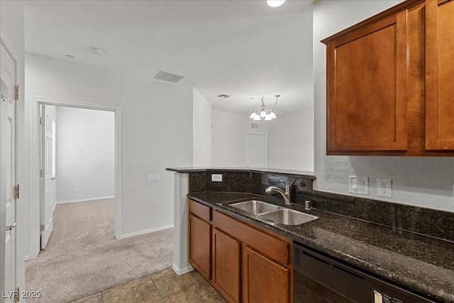 6868 Sky Pointe Dr Unit 2035, Las Vegas, NV 89131 - kitchen with black dishwasher, light carpet, brown cabinetry, dark stone countertops, and a chandelier