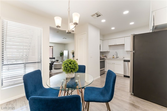 3151 Soaring Gulls Dr Unit 1021, Las Vegas, NV 89128 - dining space featuring light wood-style floors, a chandelier, and recessed lighting
