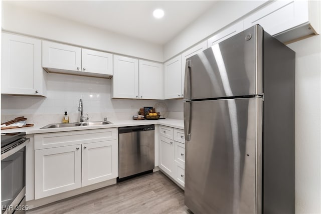 3151 Soaring Gulls Dr Unit 1021, Las Vegas, NV 89128 - kitchen featuring appliances with stainless steel finishes, white cabinetry, light countertops, decorative backsplash, and recessed lighting