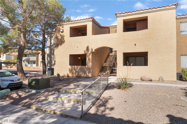 3151 Soaring Gulls Dr Unit 1021, Las Vegas, NV 89128 - view of front facade with stucco siding, stairs, and a tiled roof