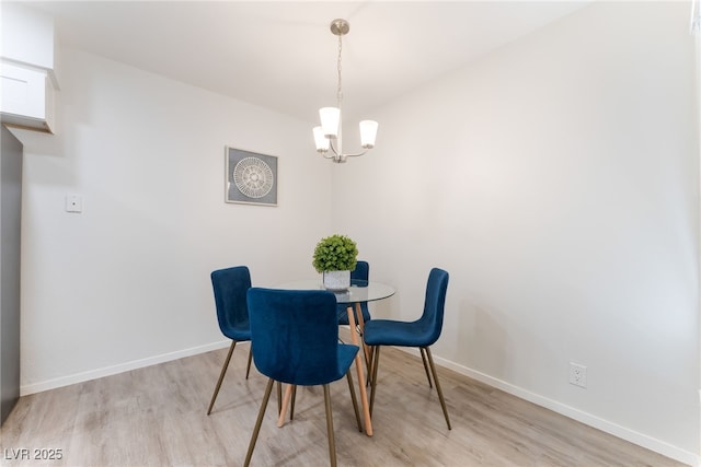 3151 Soaring Gulls Dr Unit 1021, Las Vegas, NV 89128 - dining area featuring light wood-style flooring and a chandelier