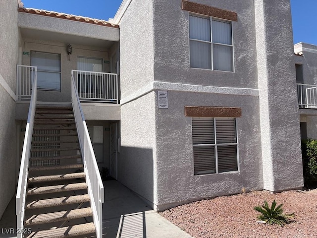 6800 E Lake Mead Blvd Unit 2024, Las Vegas, NV 89156 - view of side of home with stairs and stucco siding